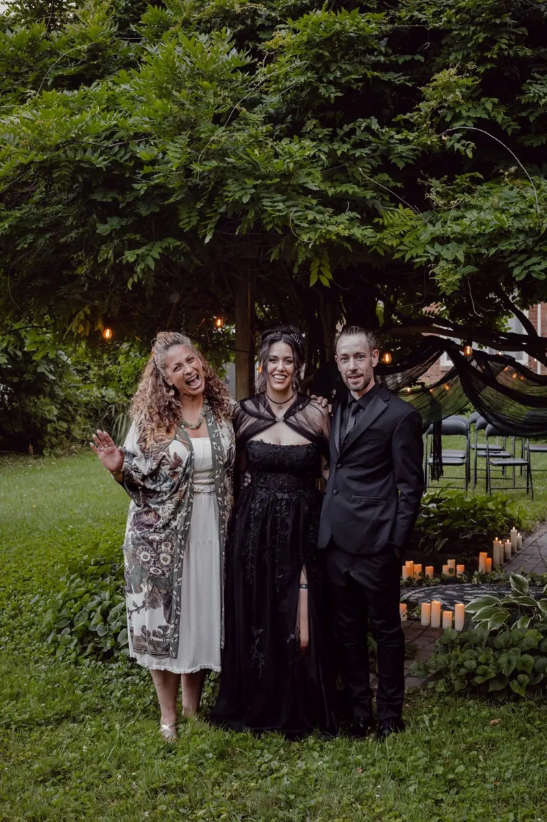 Natalia celebrating with a newly married couple at their garden wedding
