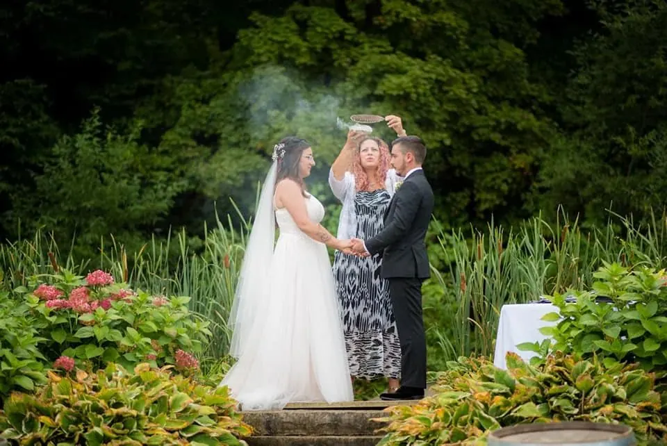 Natalia officiating a sacred outdoor wedding ceremony