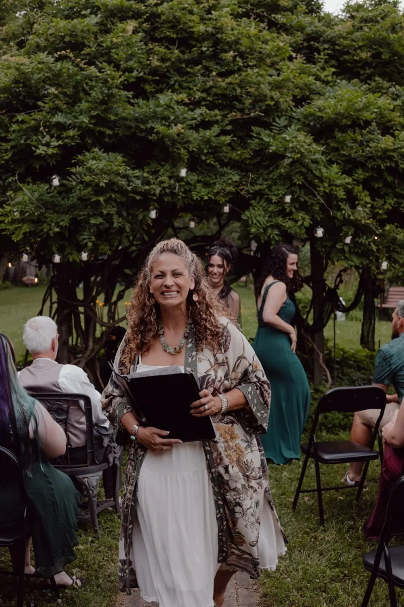 Natalia smiling after officiating an outdoor wedding ceremony